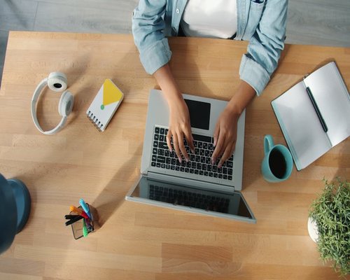 Person working on a laptop at a desk